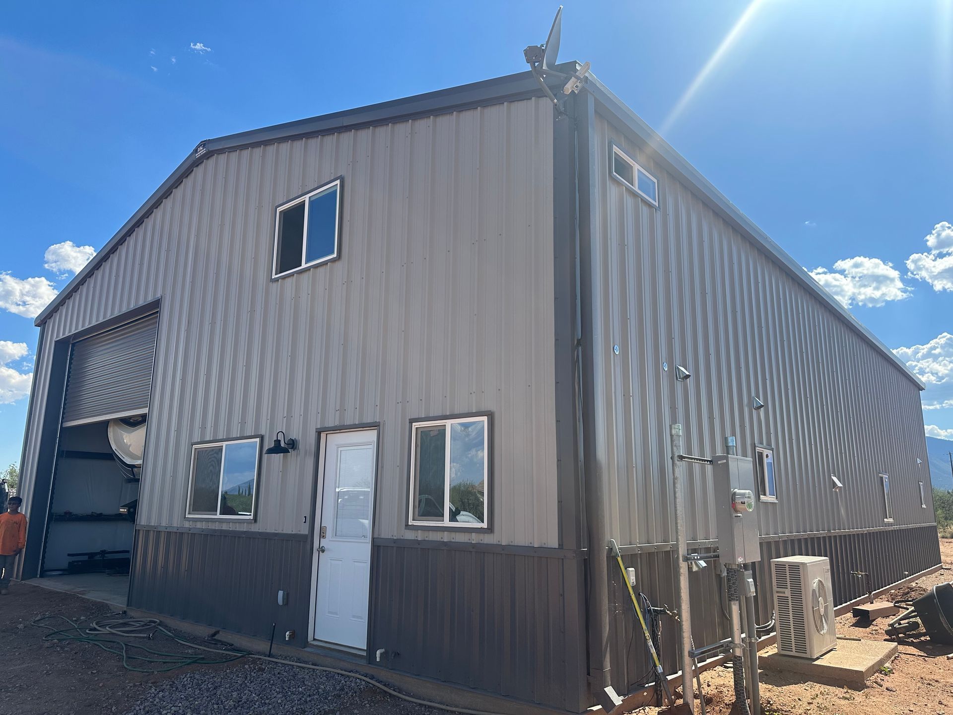 A large metal building with a lot of windows and doors.