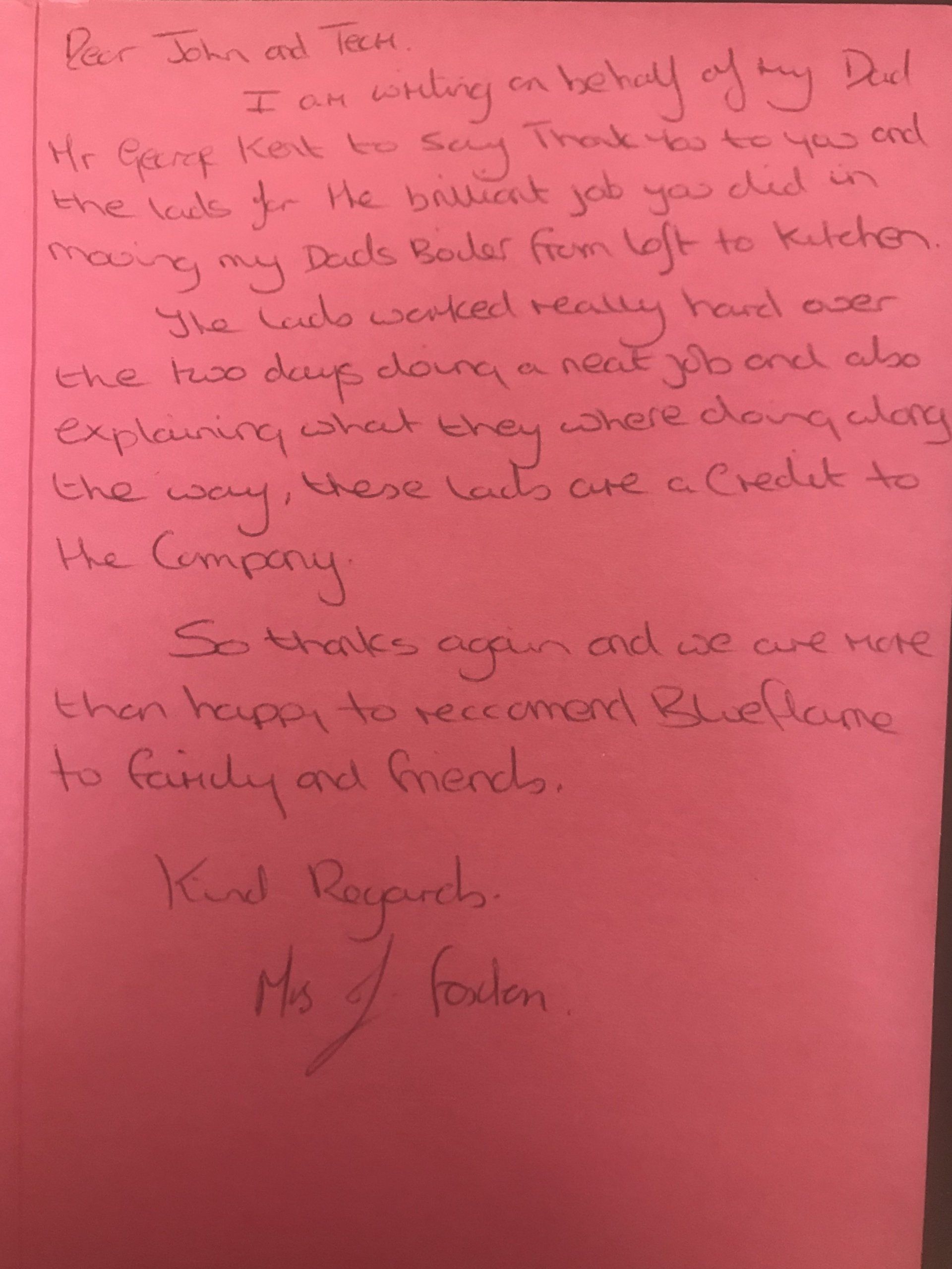 A pink piece of paper with handwriting on it