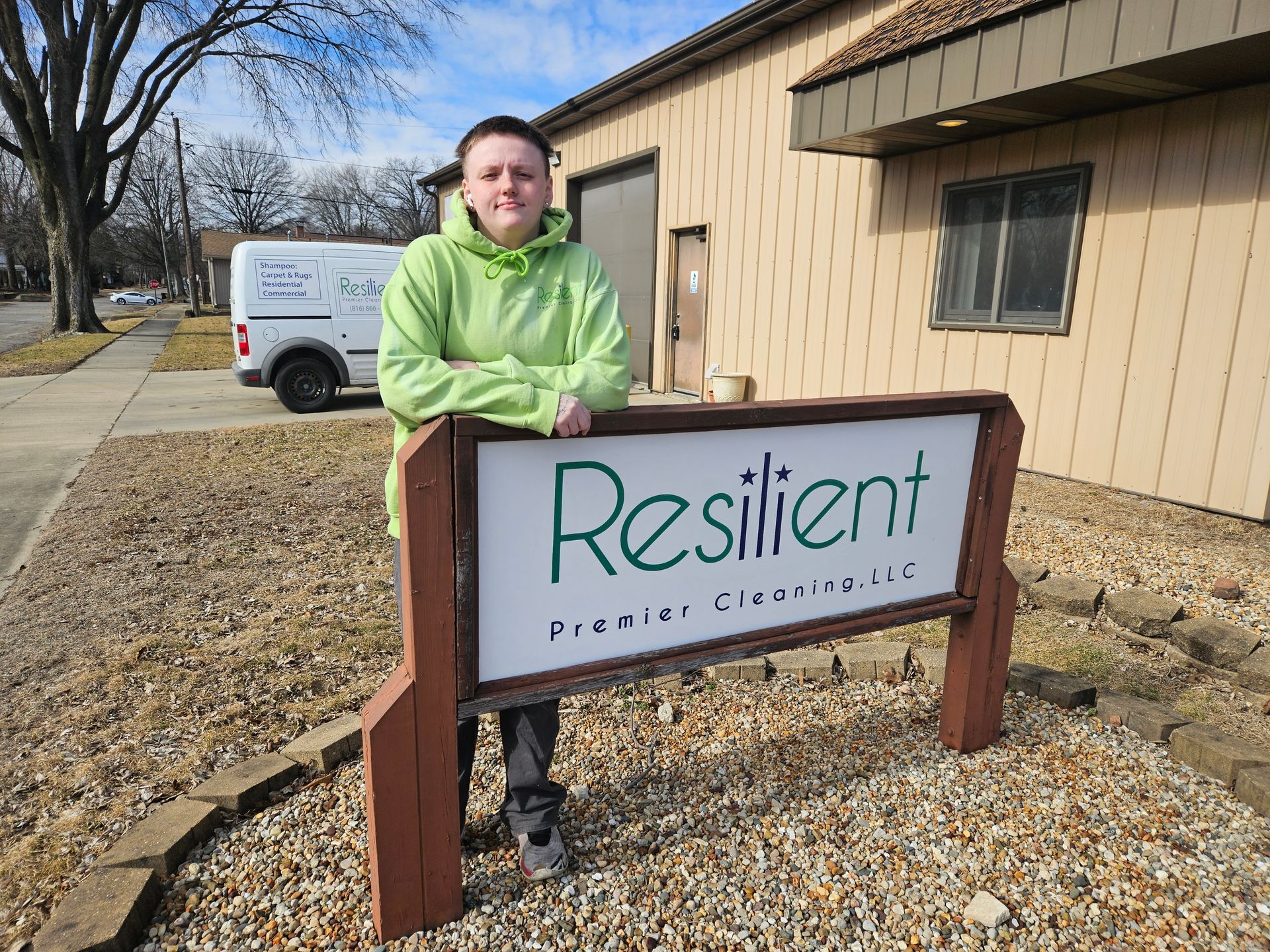 Person in a green hoodie stands by a 