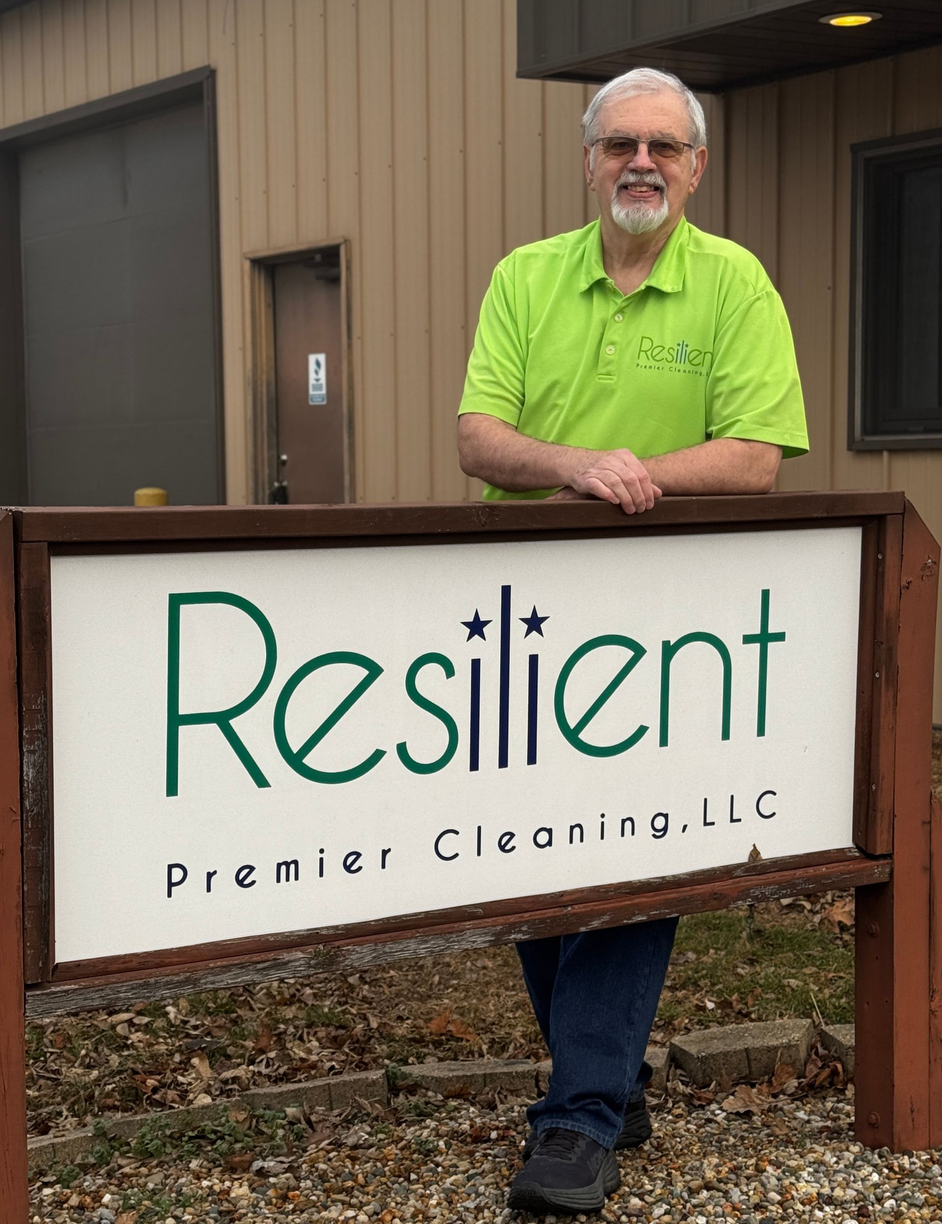 Man in green shirt stands behind 