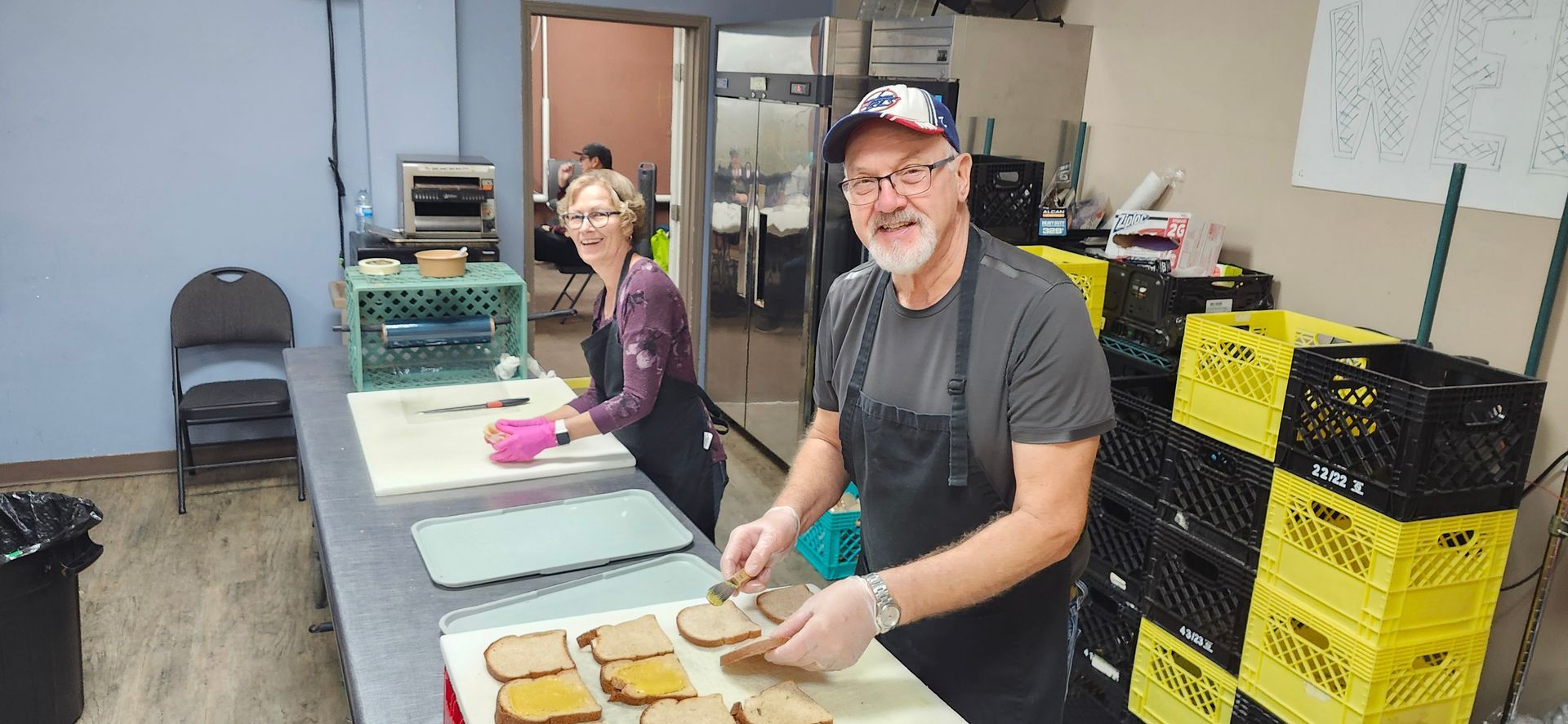 A group of people are posing for a picture in a kitchen.