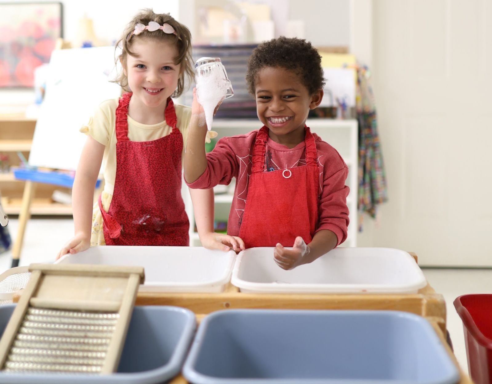 Montessori child washing dishes