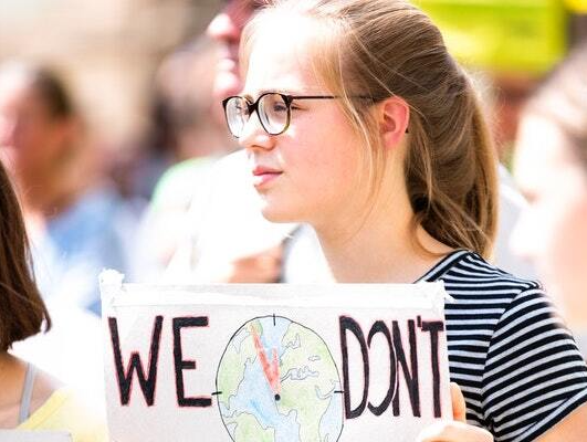 Montessori student holding a sign
