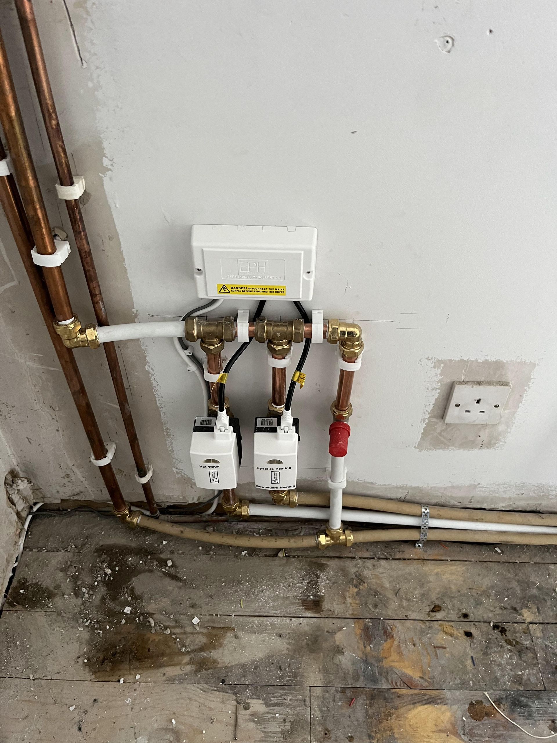 There are a lot of pipes connected to the wall.