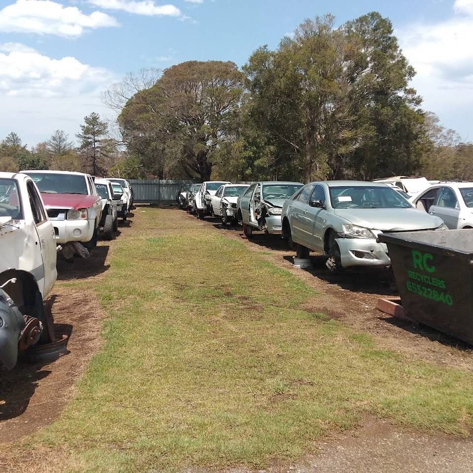 A Row Of Semi Trucks Are Driving Down A Highway — Old Bar Wreckers In Port Macquarie, NSW