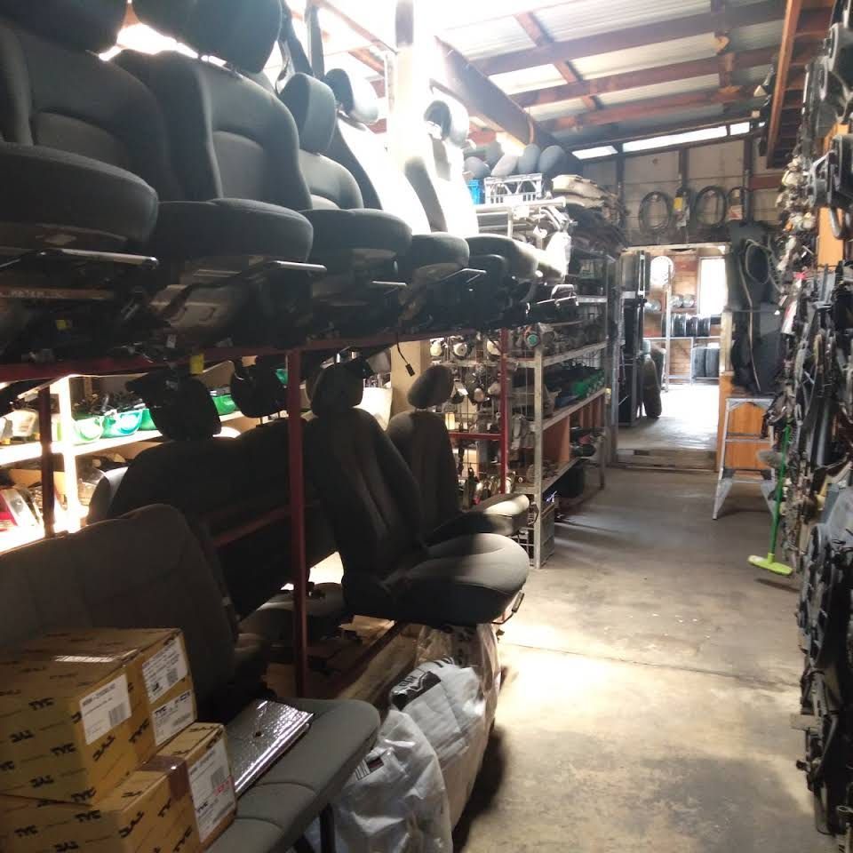 A Black Car Is Sitting On Top Of A Yellow Tow Truck — Old Bar Wreckers In Hallidays Point, NSW