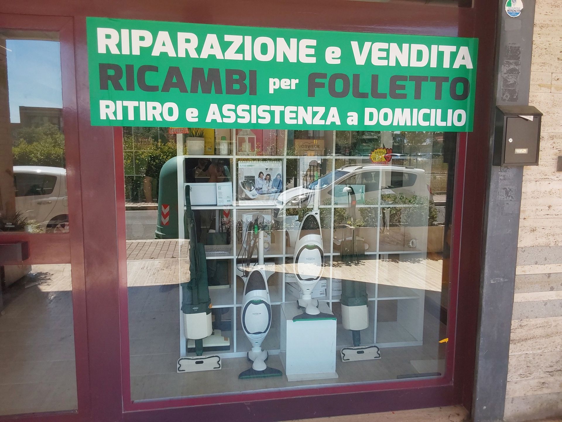 A store front with a green sign that says 