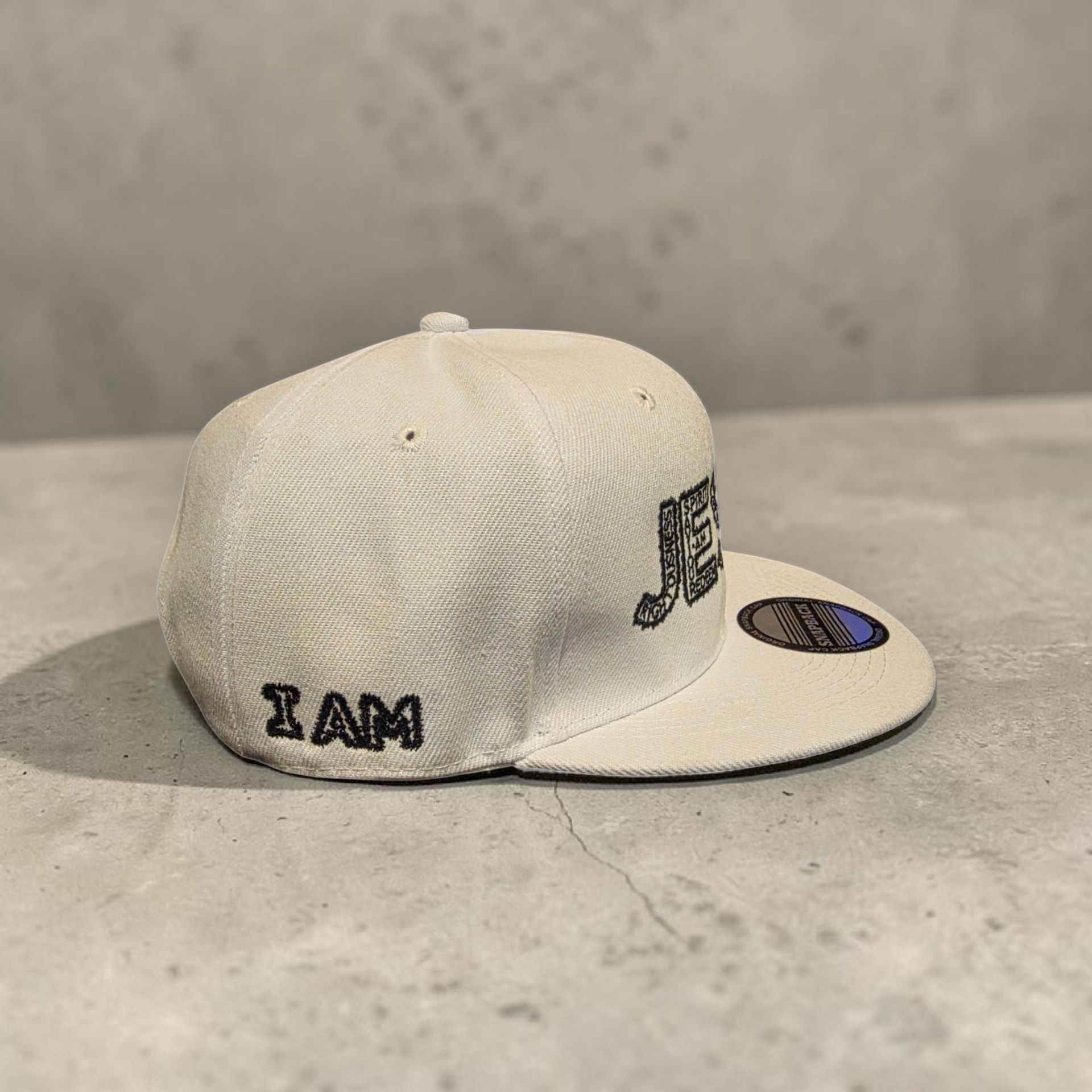 White hat with black letters