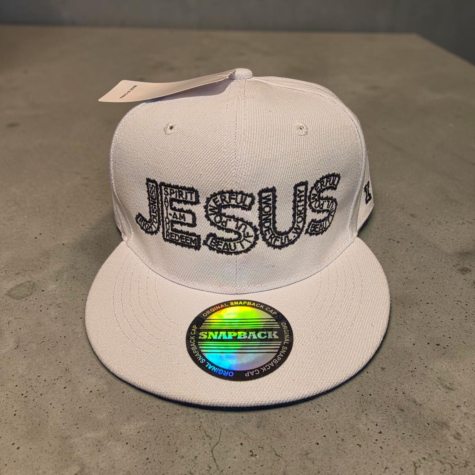 White hat with black letters