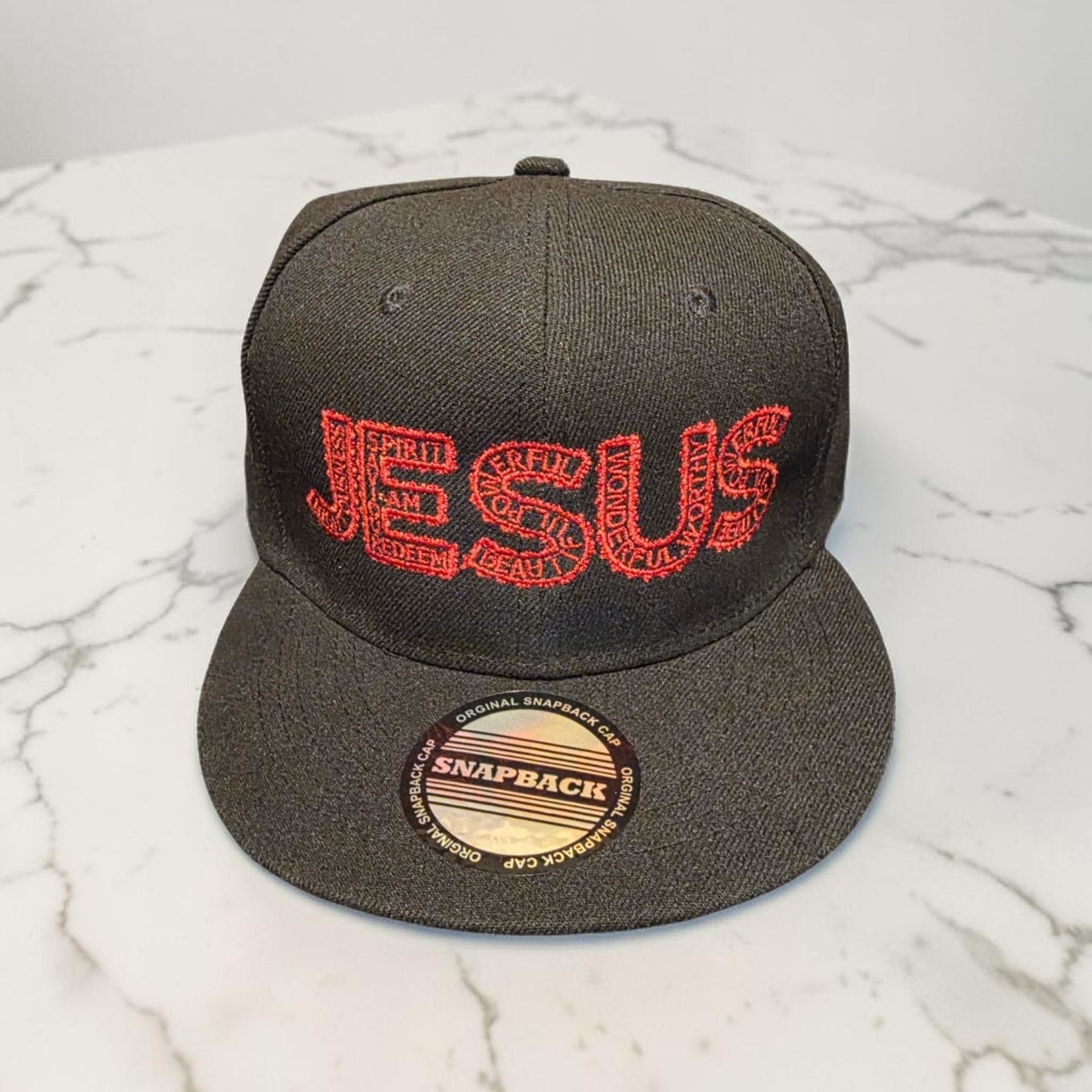 Black hat with red letters