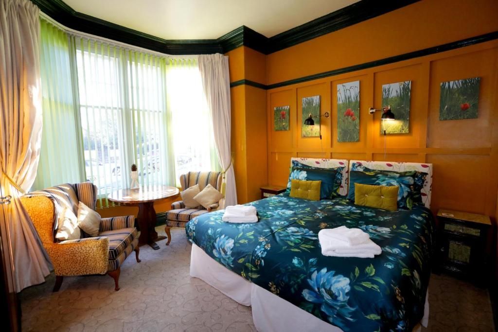 a hotel room with a large bed and a table