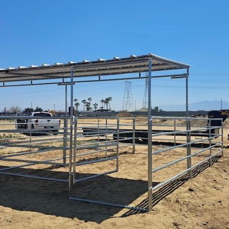 A metal structure in the middle of a dirt field.