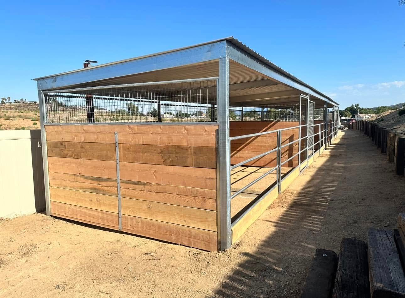 A horse stable with a metal frame and wooden walls.
