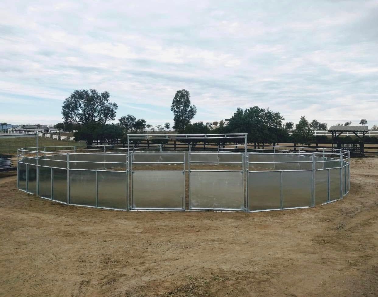 A large metal fence is surrounding a large body of water.
