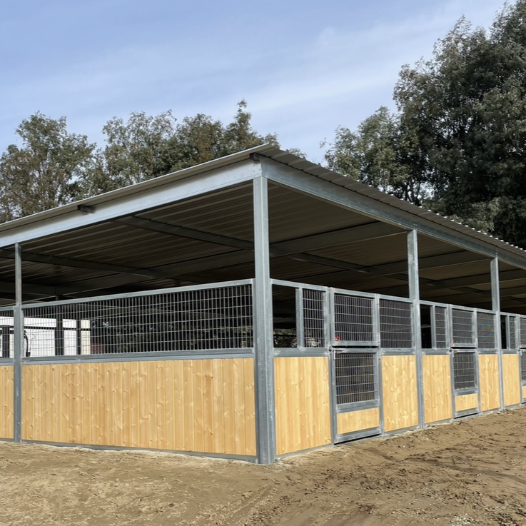 A horse stable with a metal roof and wooden walls.