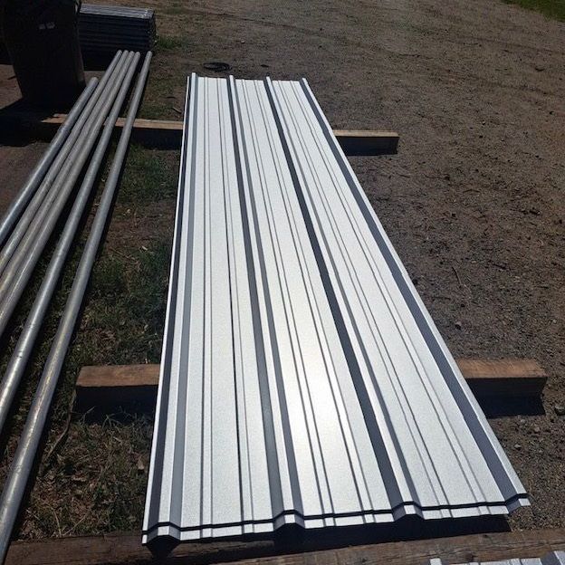 A metal roof sitting on top of a wooden pallet