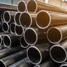A pile of metal pipes stacked on top of each other in a warehouse.