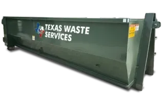 A green dumpster with a yellow trim sits in the snow