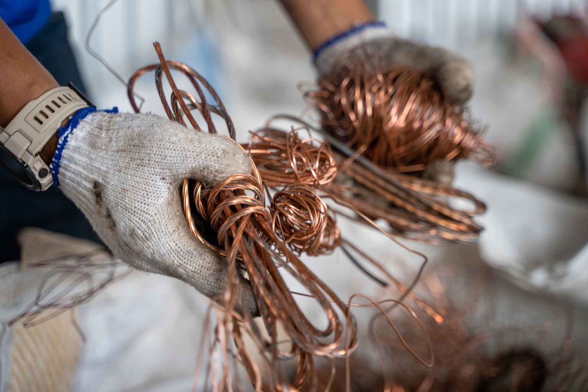 A person is holding a bunch of copper wires in their hands.