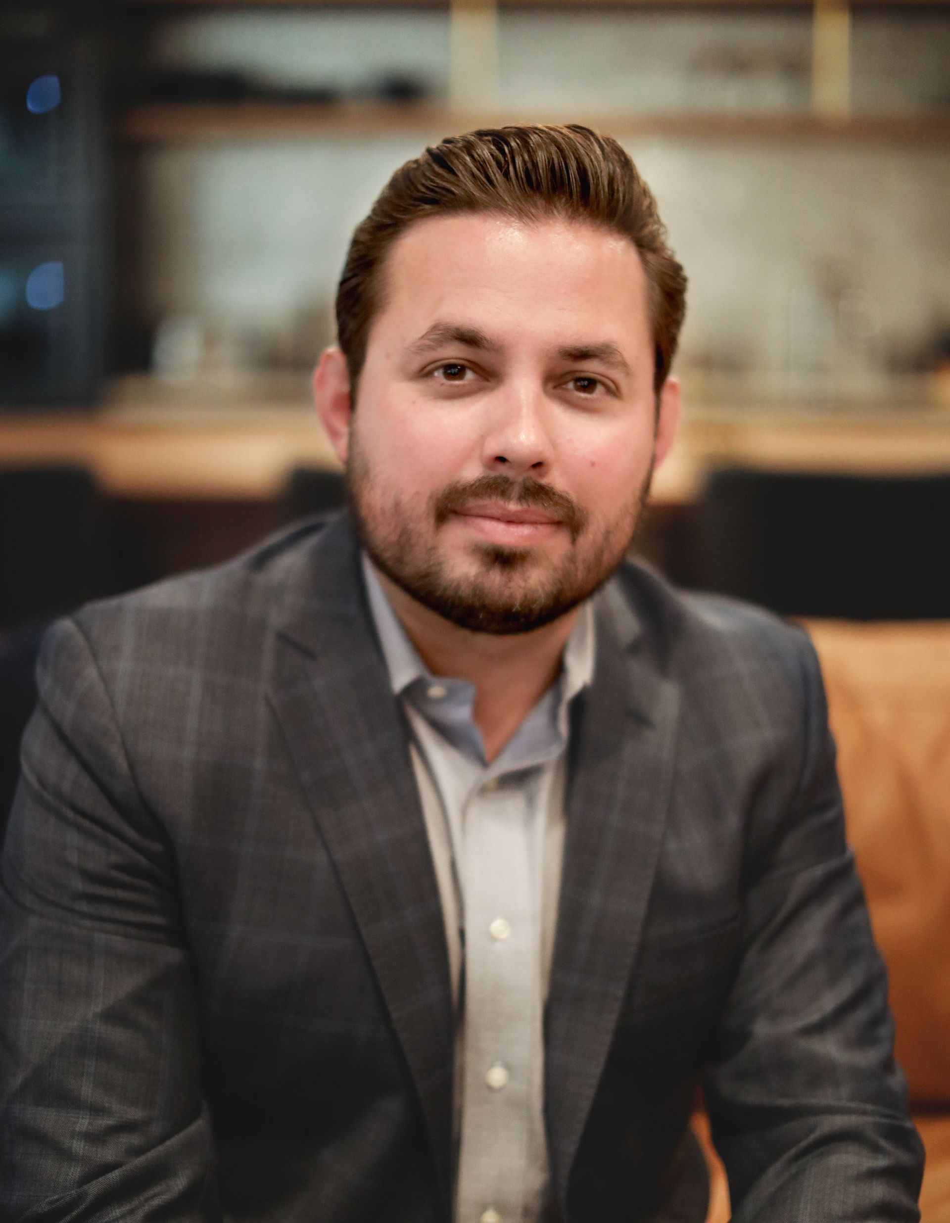 A man in a suit and tie is smiling for the camera.