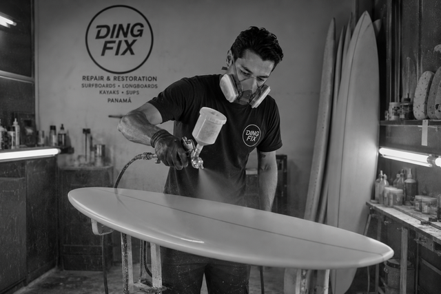 Surfboard ding repair in a workshop