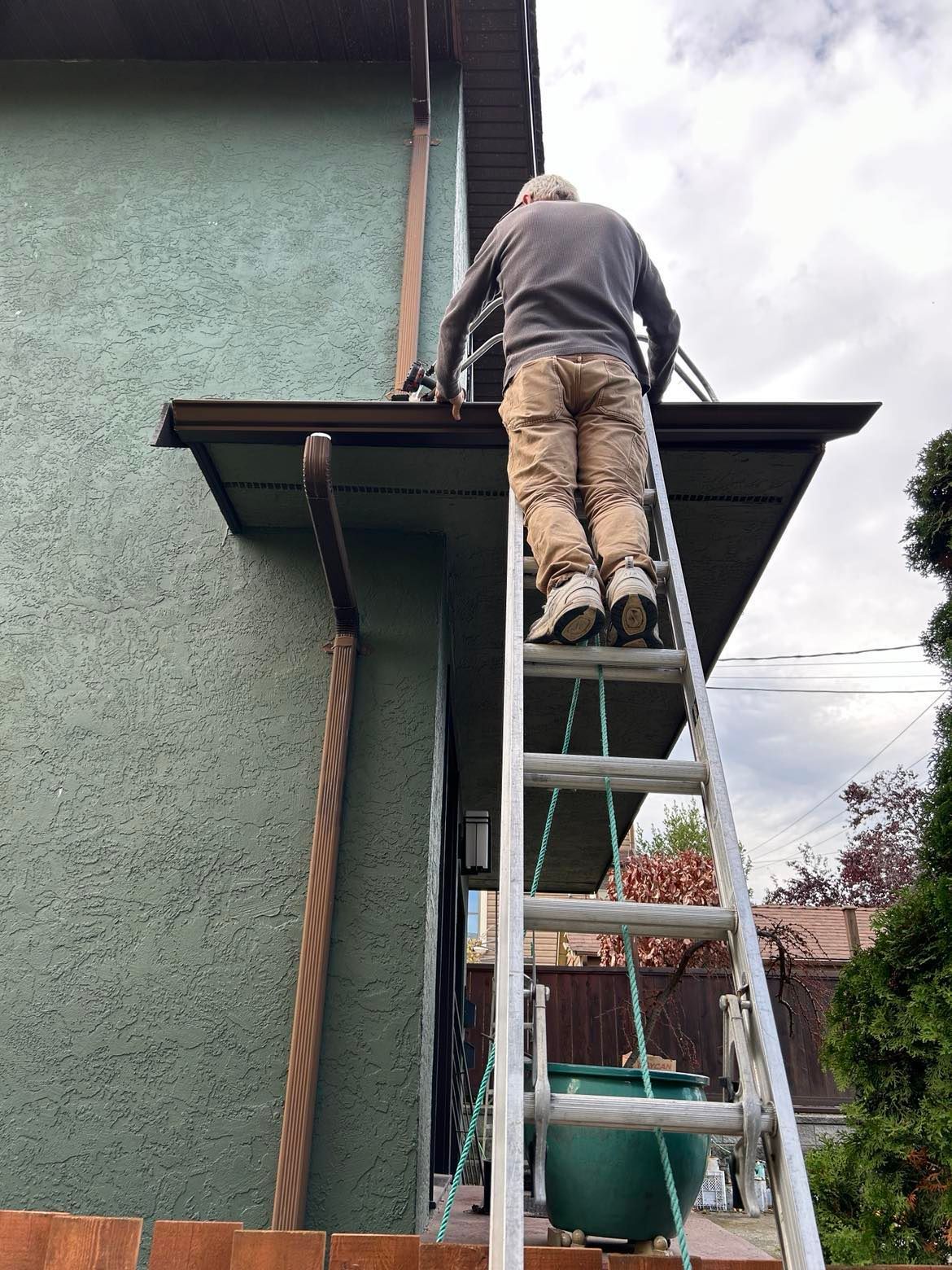 Our team member putting up a small section of gutter we replaced on a home