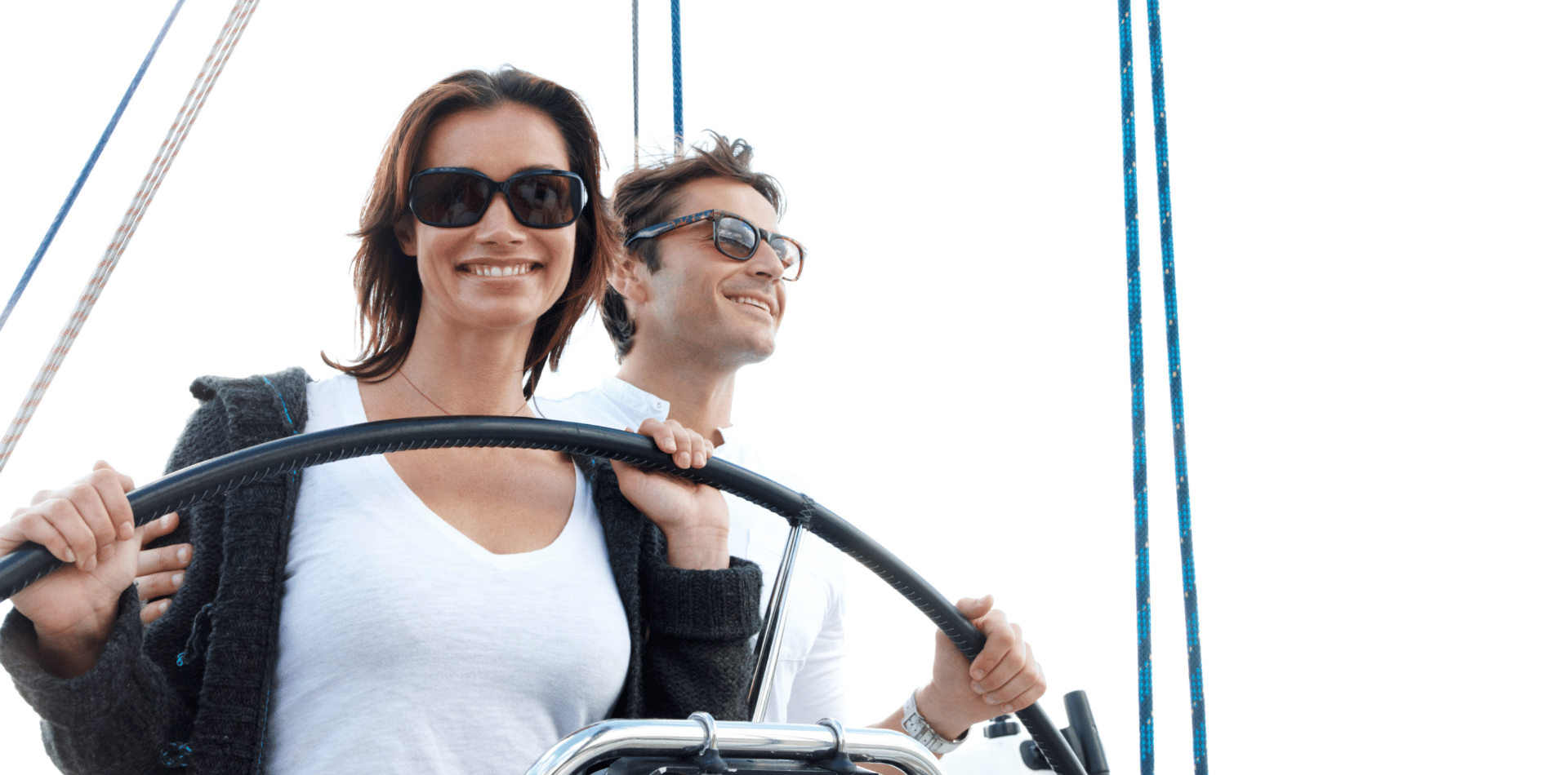A girl steering a yacht on course