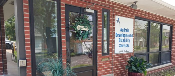 a brick building with a sign that says andrain developmental disability services