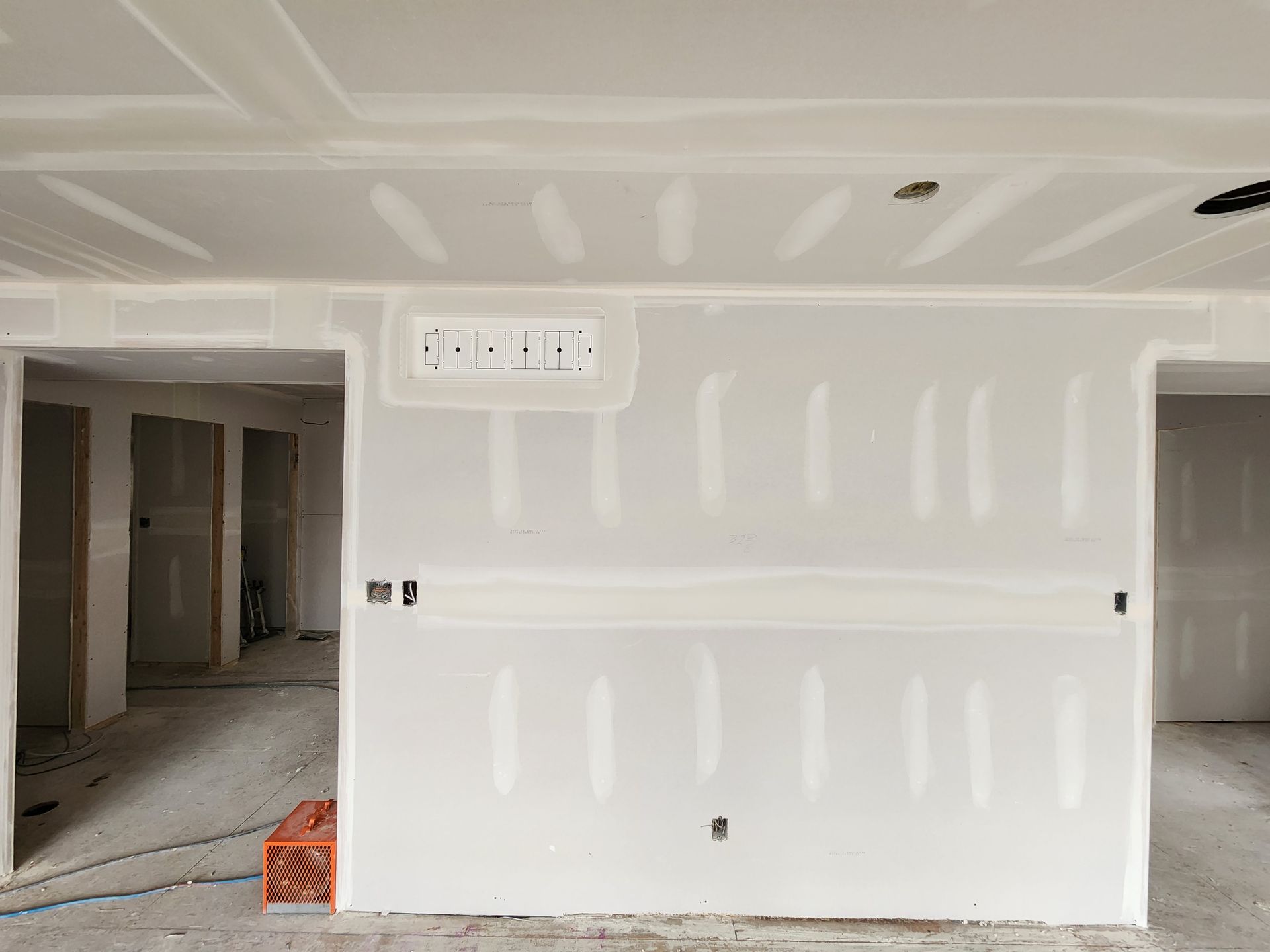 a room in a house under construction with drywall on the walls .
