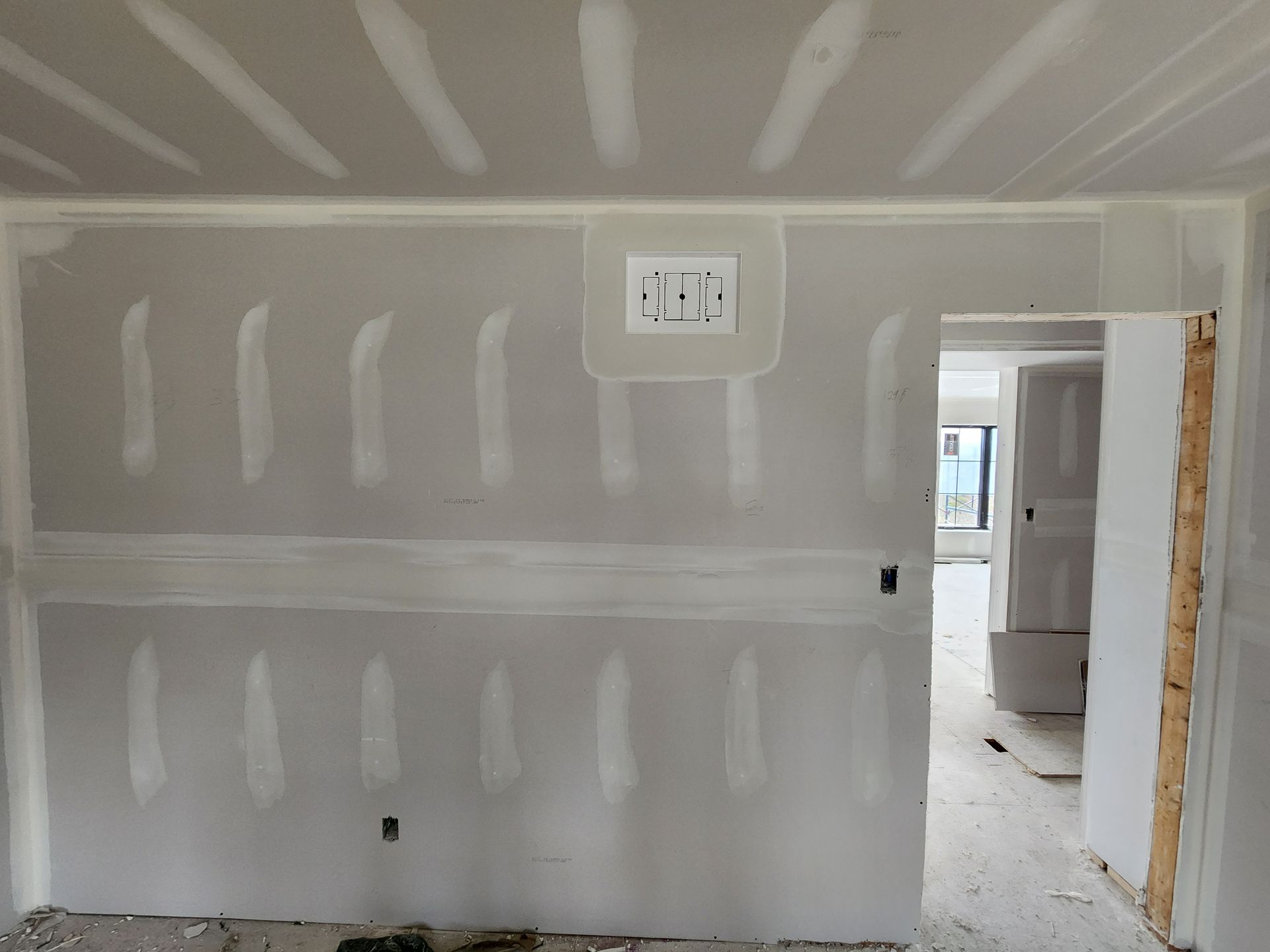 an empty room with drywall walls and a door