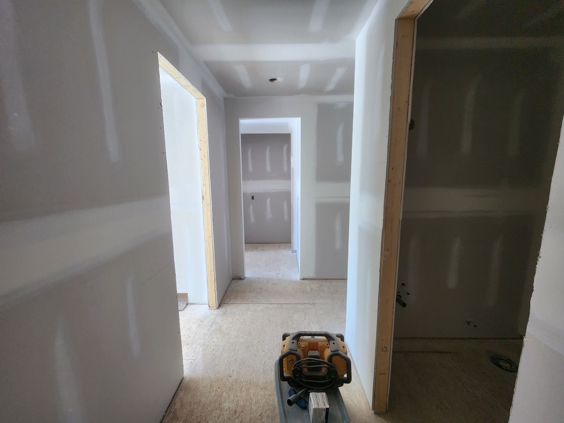 a hallway in a house under construction with drywall on the walls