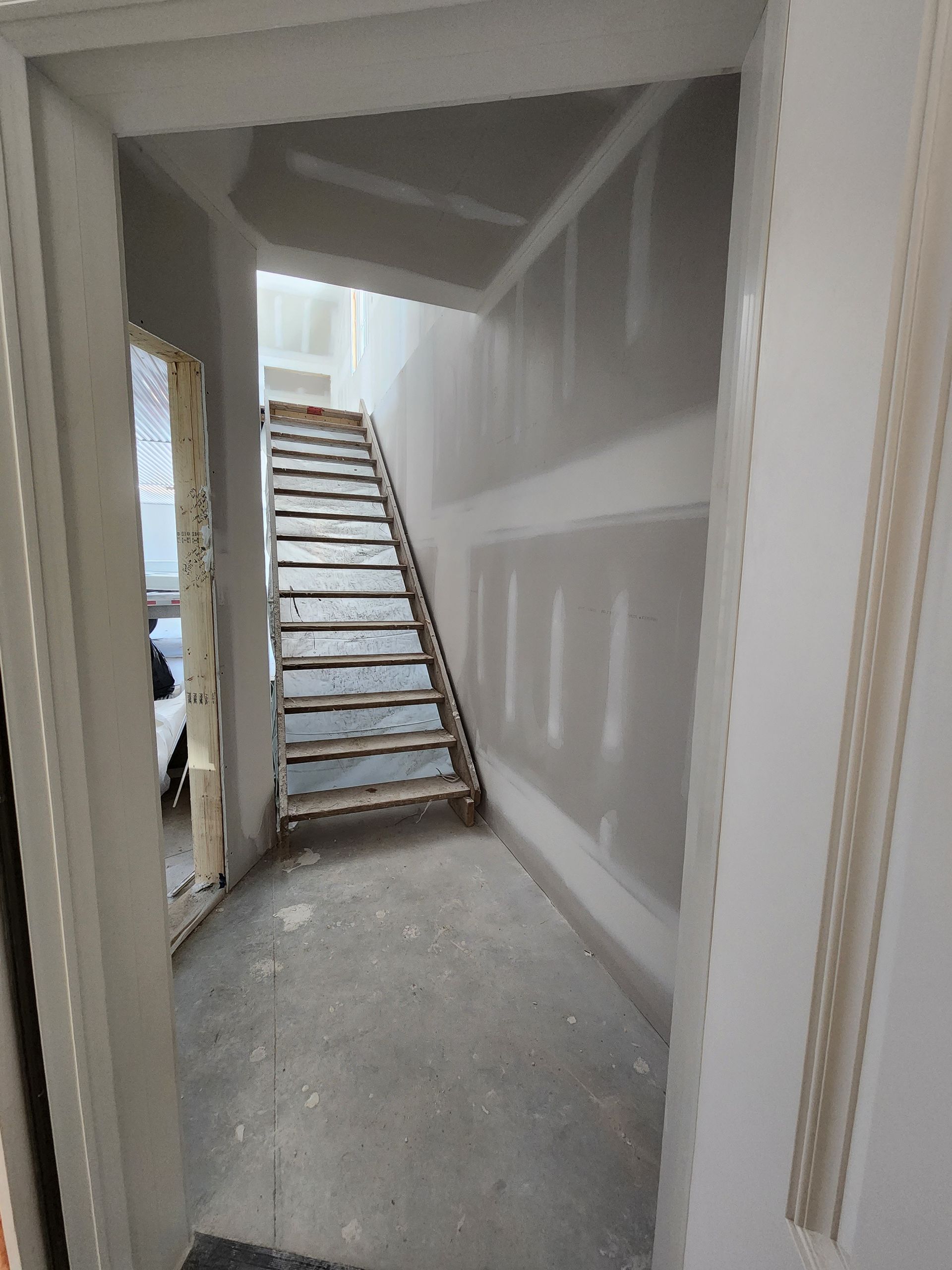 a hallway with stairs going up to the second floor