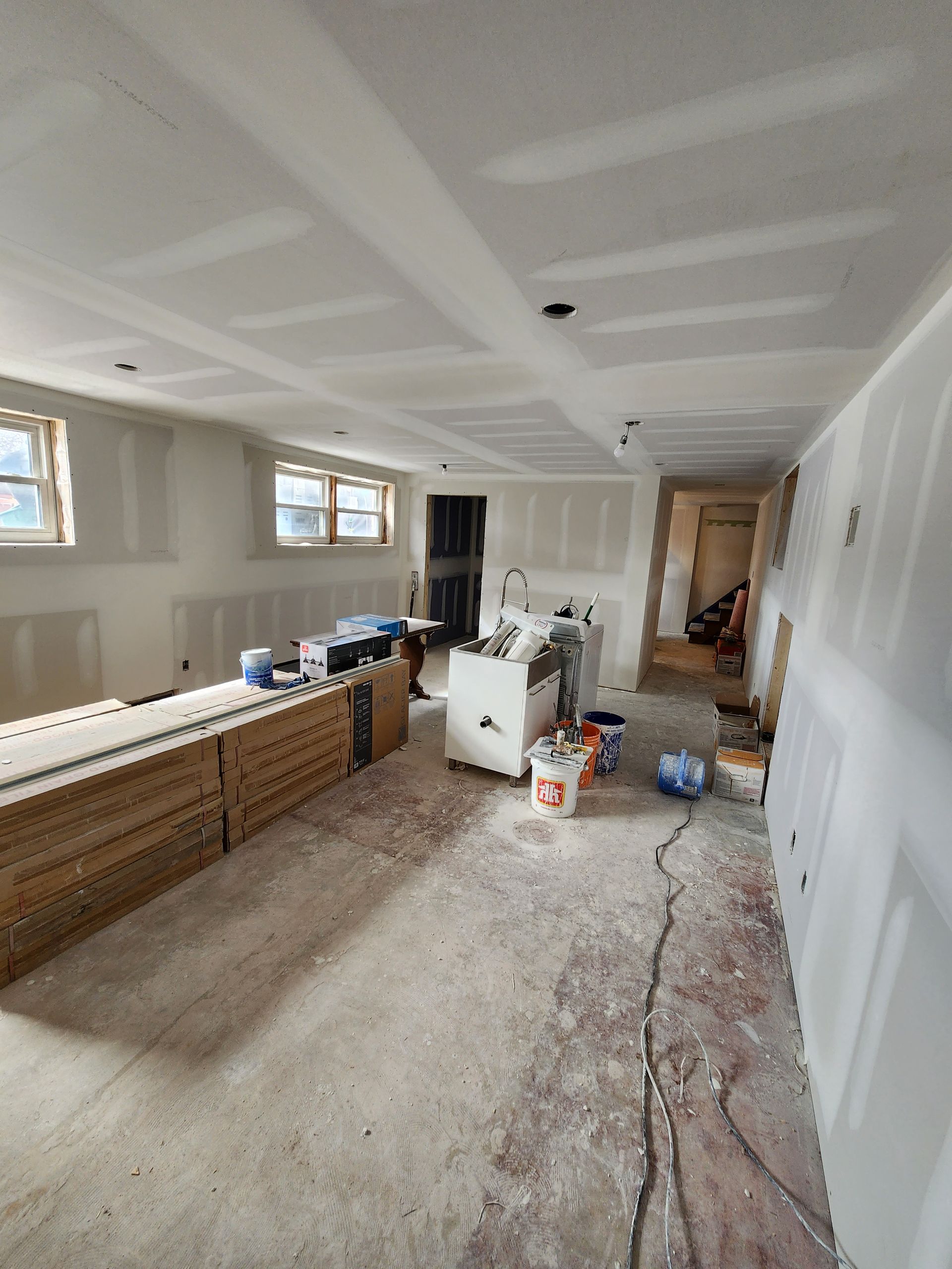 a room with a couch and a table in it is being remodeled .