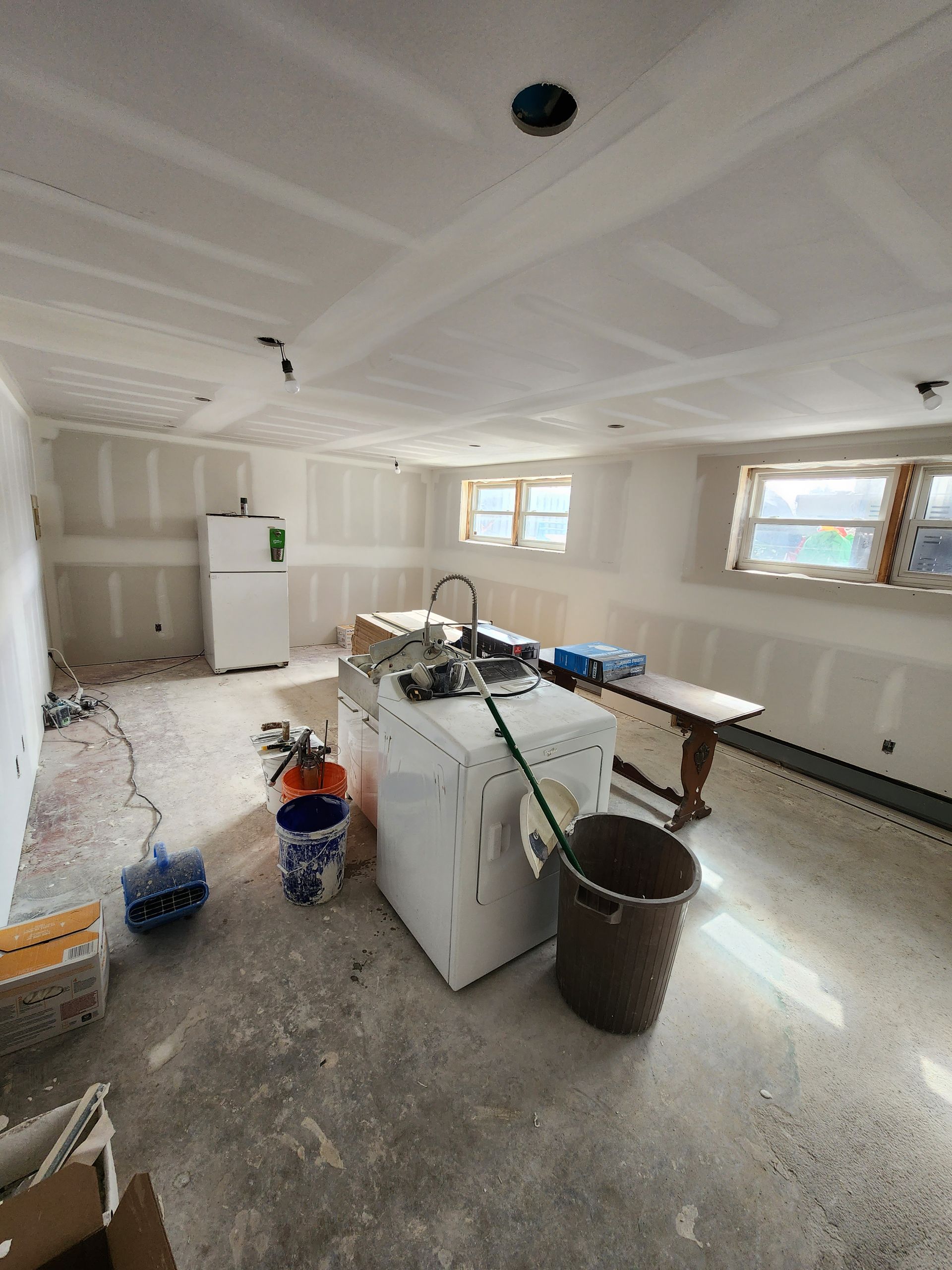 a laundry room under construction with a washer and dryer .