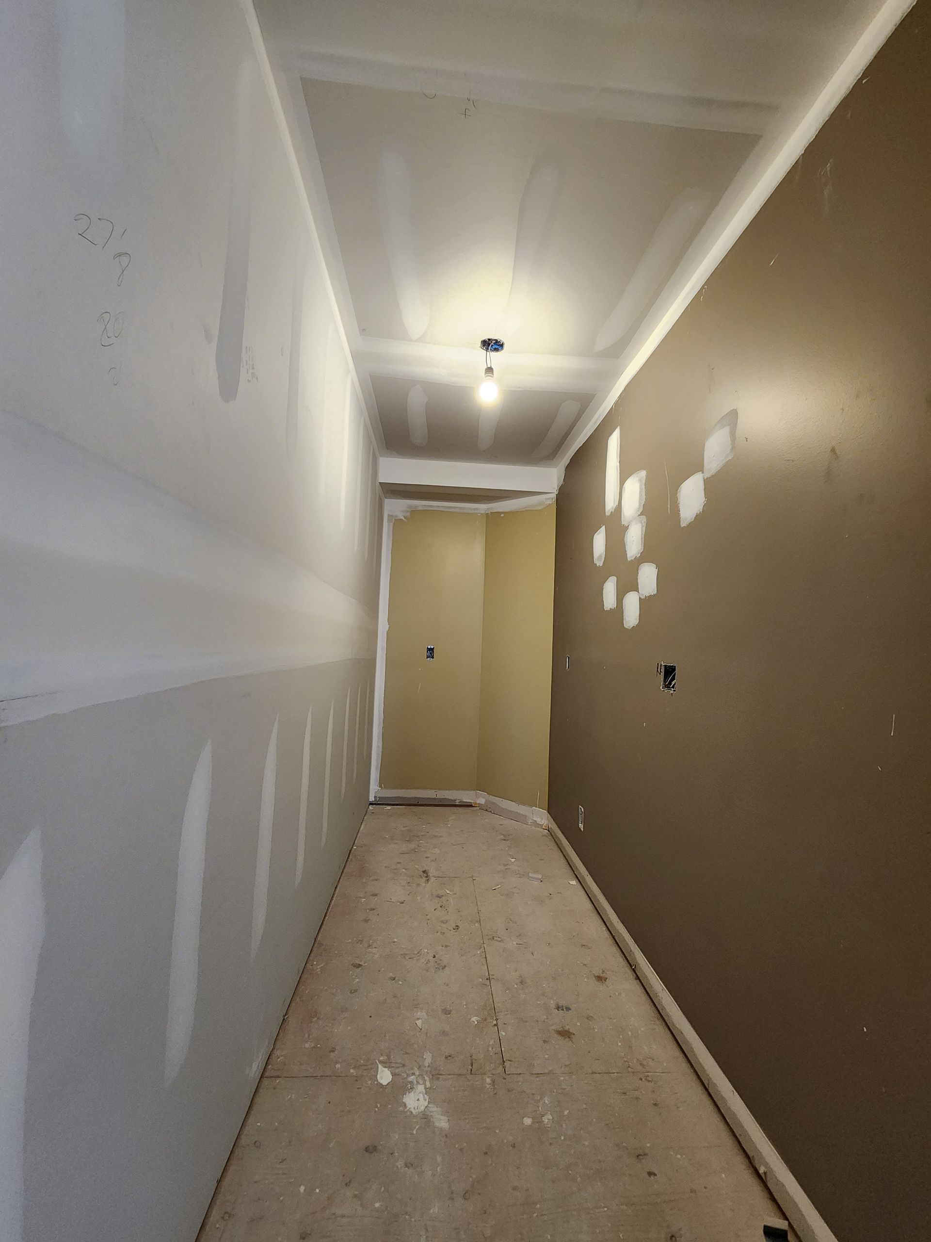a long hallway with brown walls and a light on the ceiling