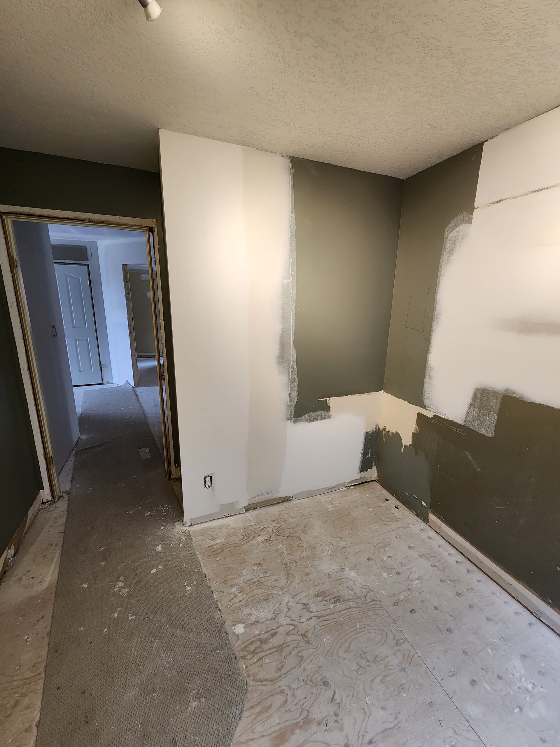 an empty room with a doorway leading to a hallway .