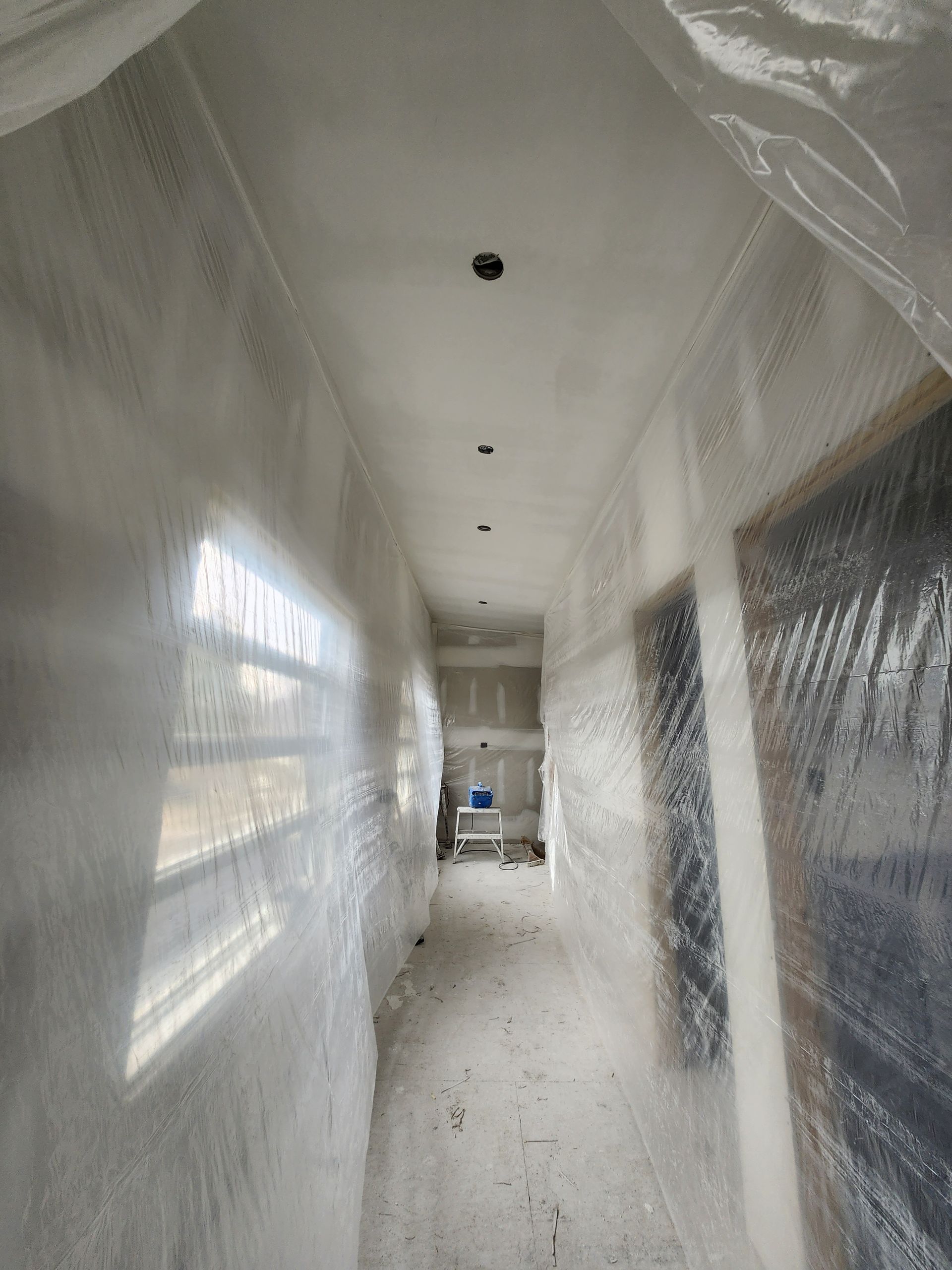 a long hallway with a lot of plastic covering it