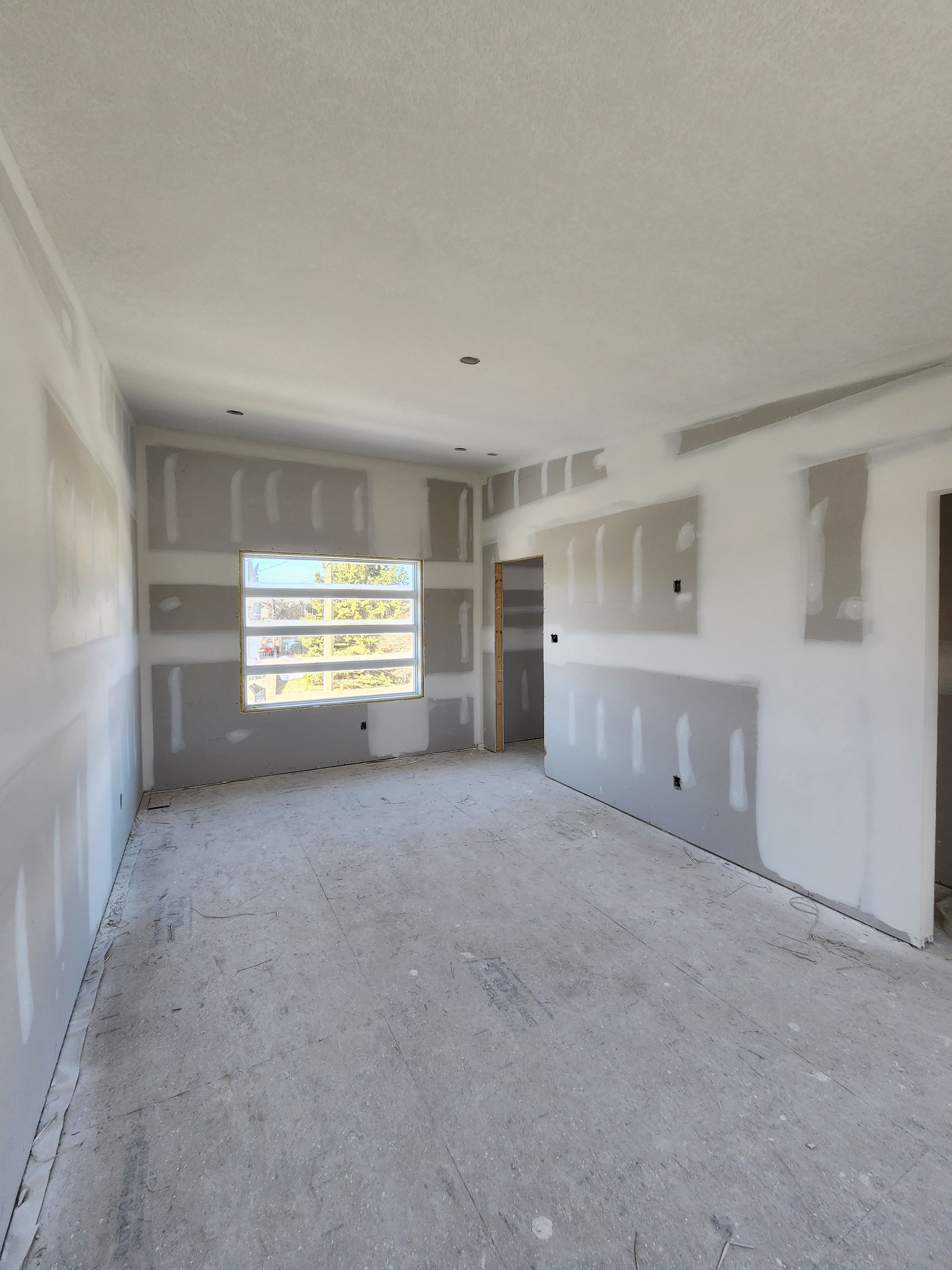 an empty room with a window and the number 1 on the wall