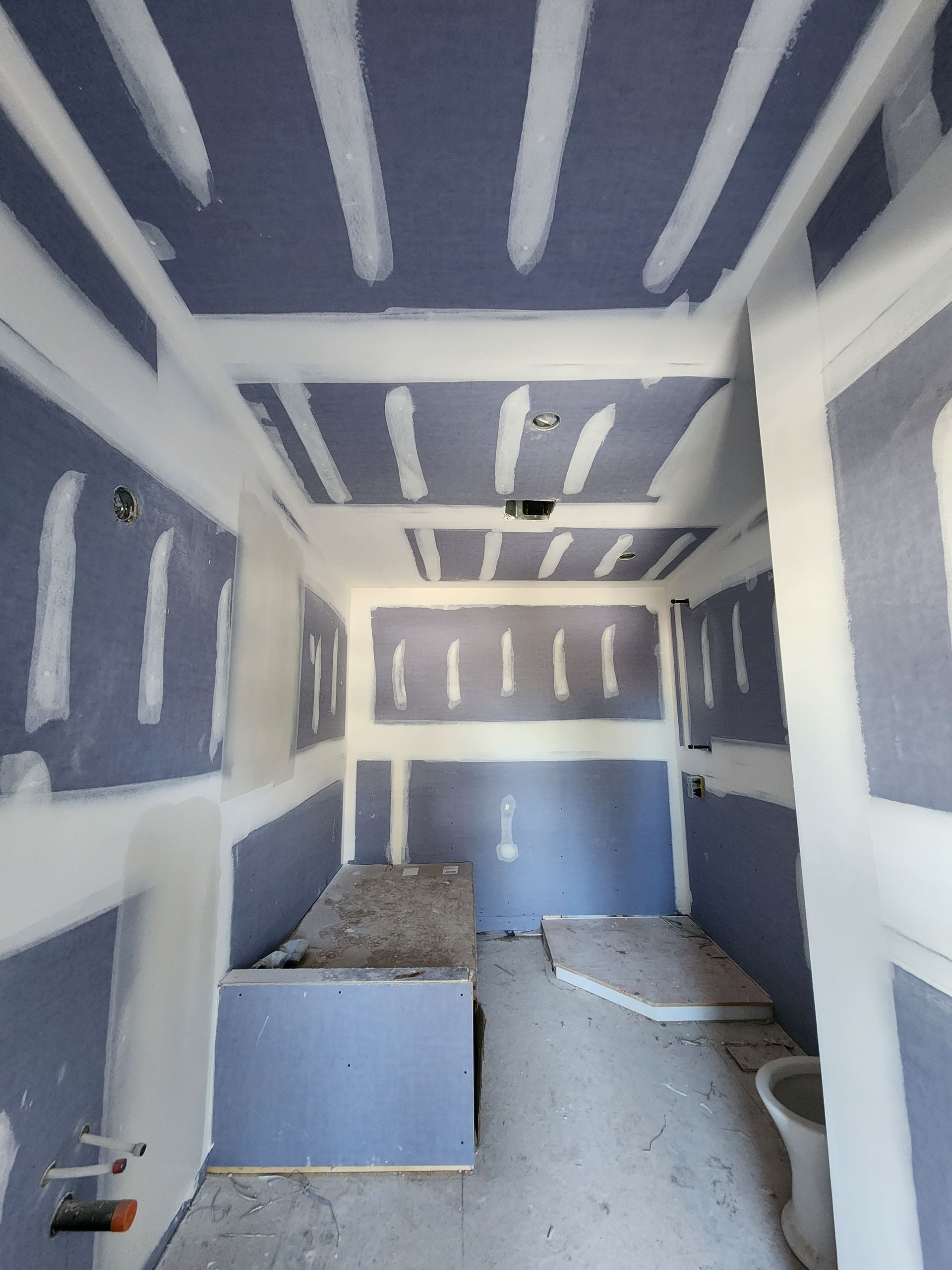 an empty room with blue walls and white trim