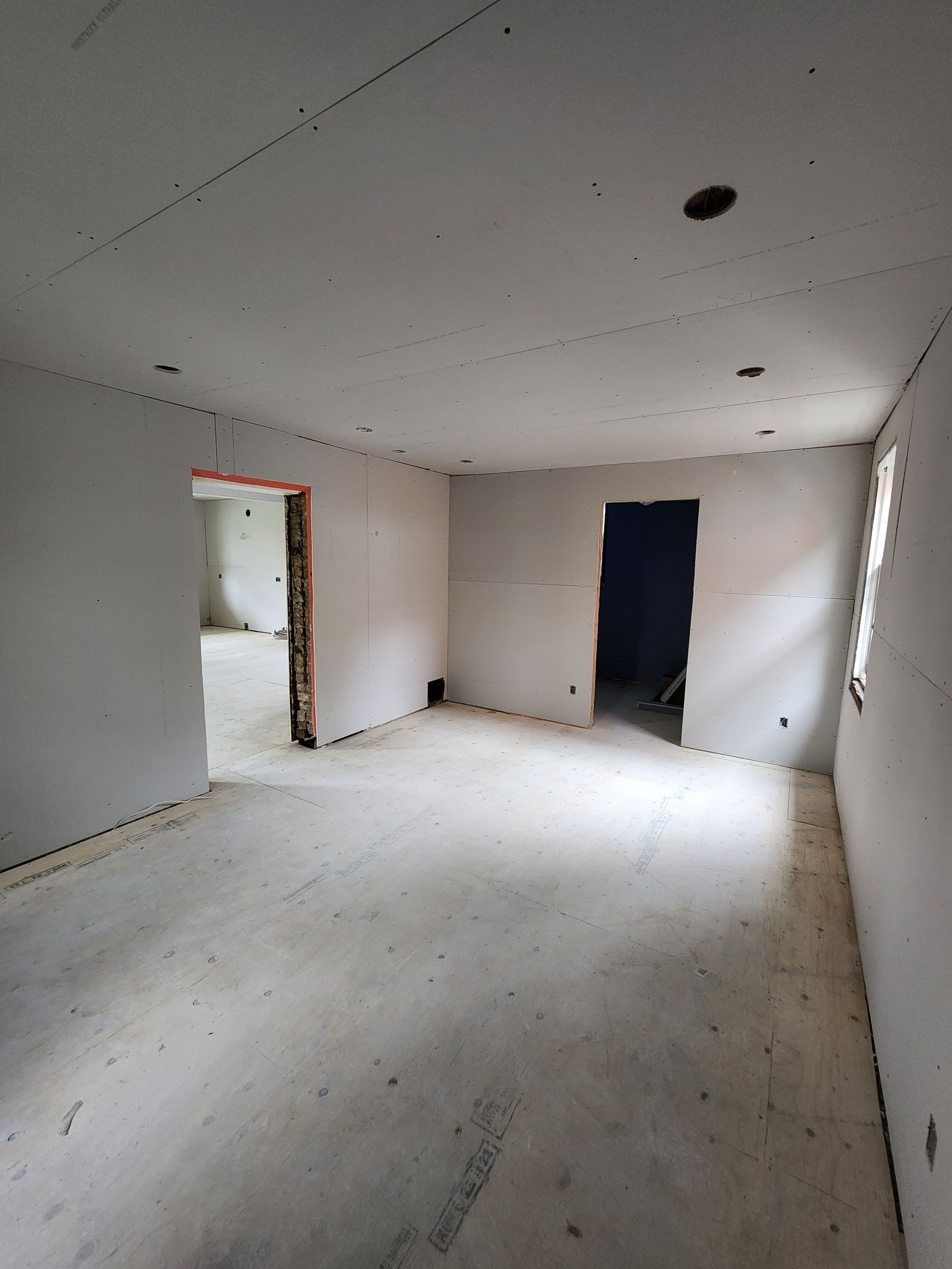 an empty room with white walls and a wooden floor