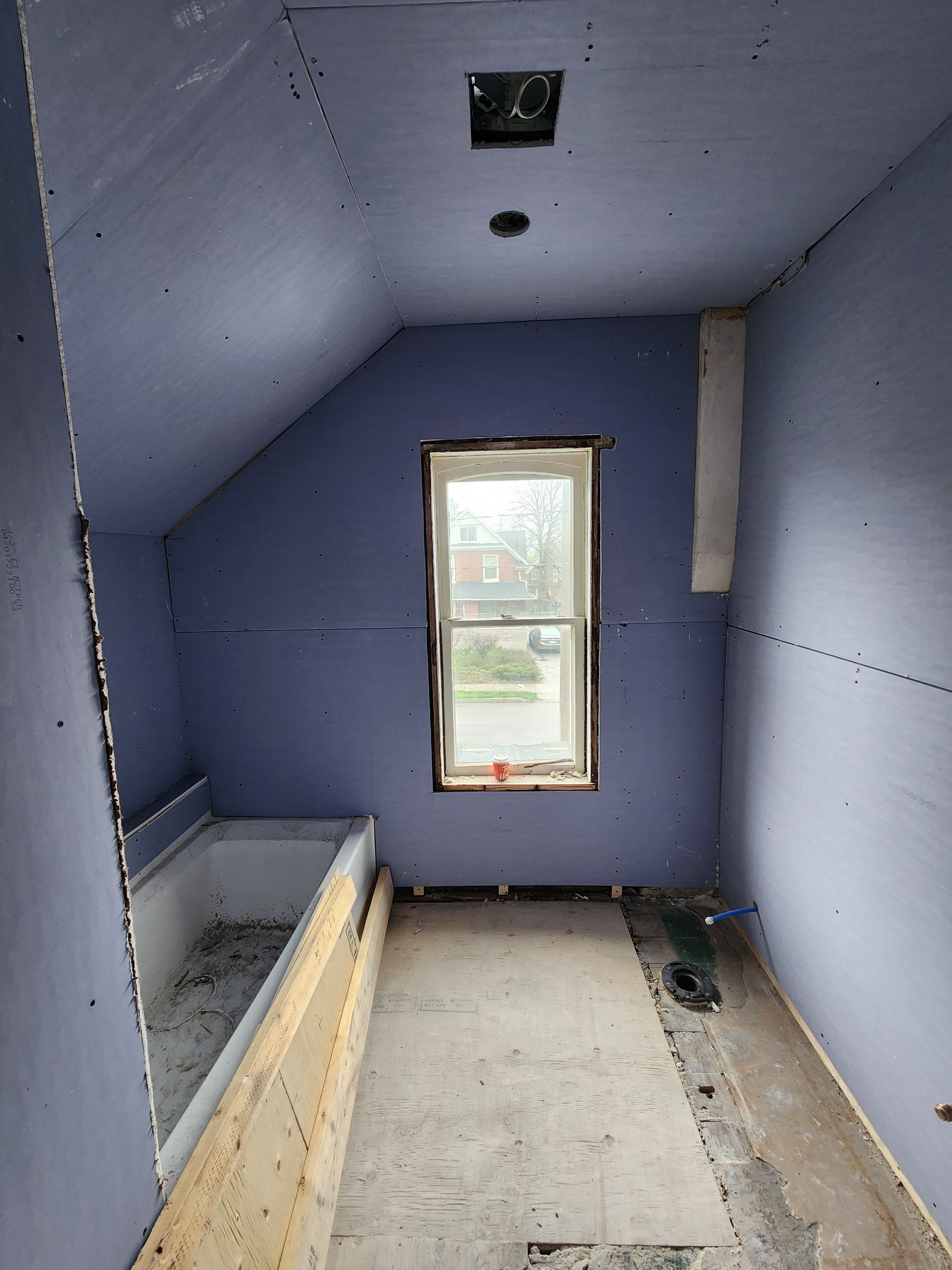 a bathroom with purple walls and a window