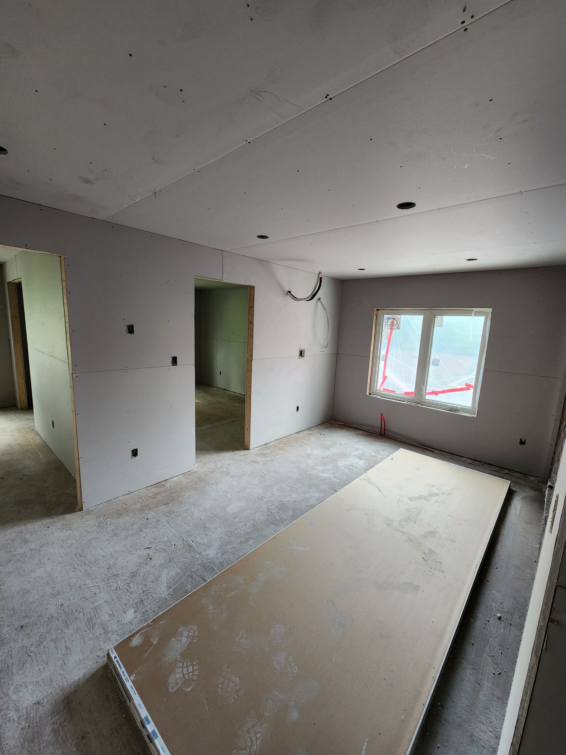 a large empty room with a table in the middle of it .