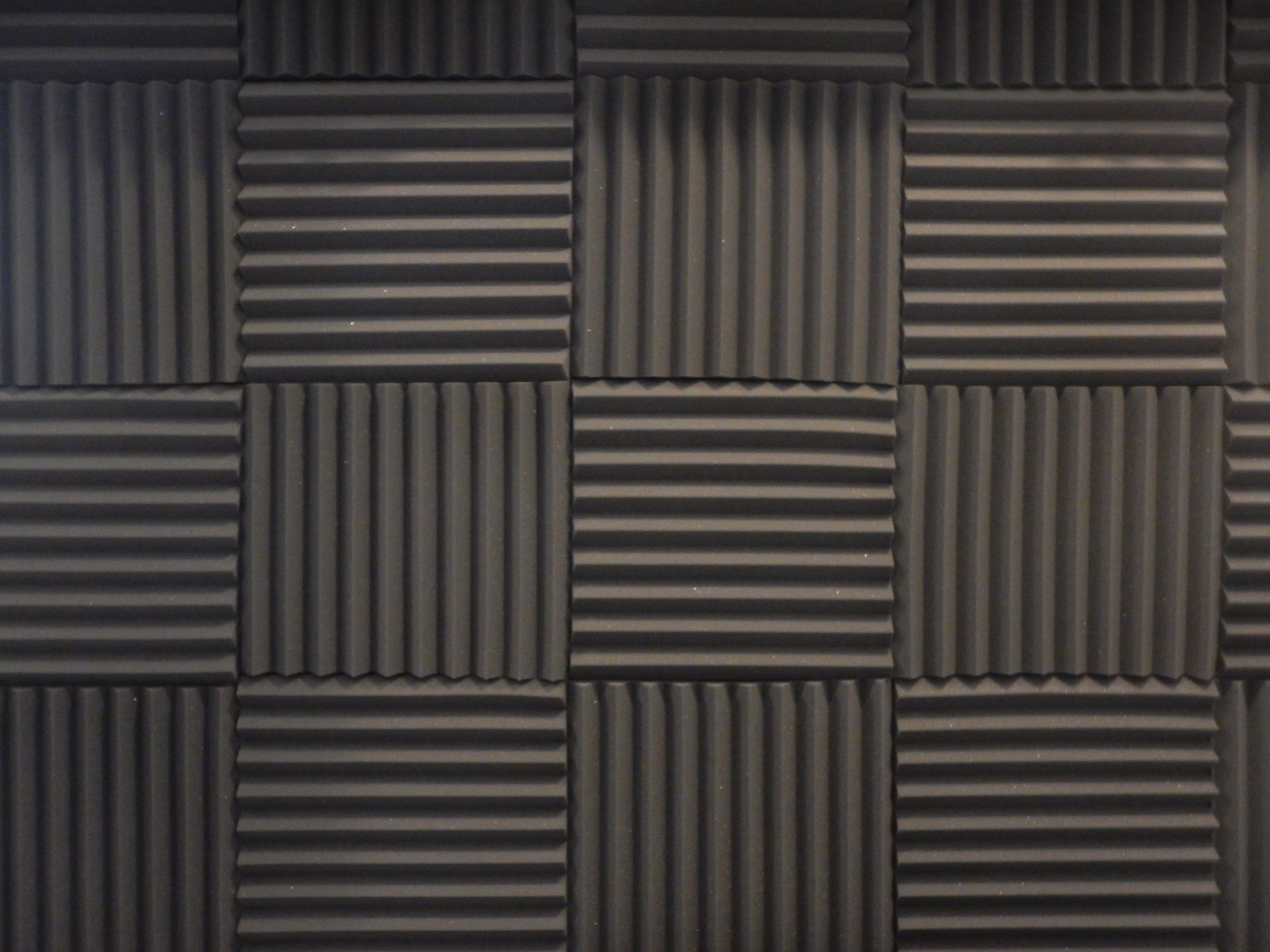 A close up of a wall with acoustic panels on it.