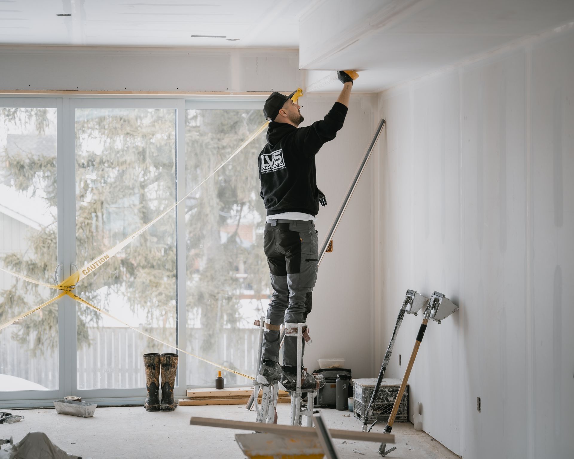 a man wearing a hard hat and an orange vest is using a tablet computer .