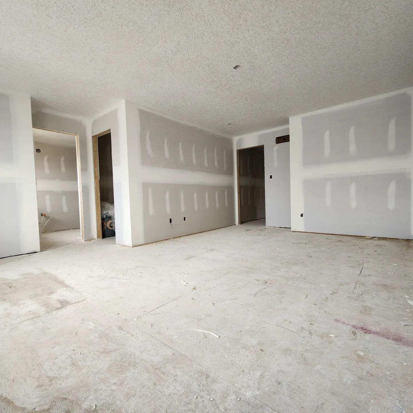 an empty room with a lot of drywall on the walls