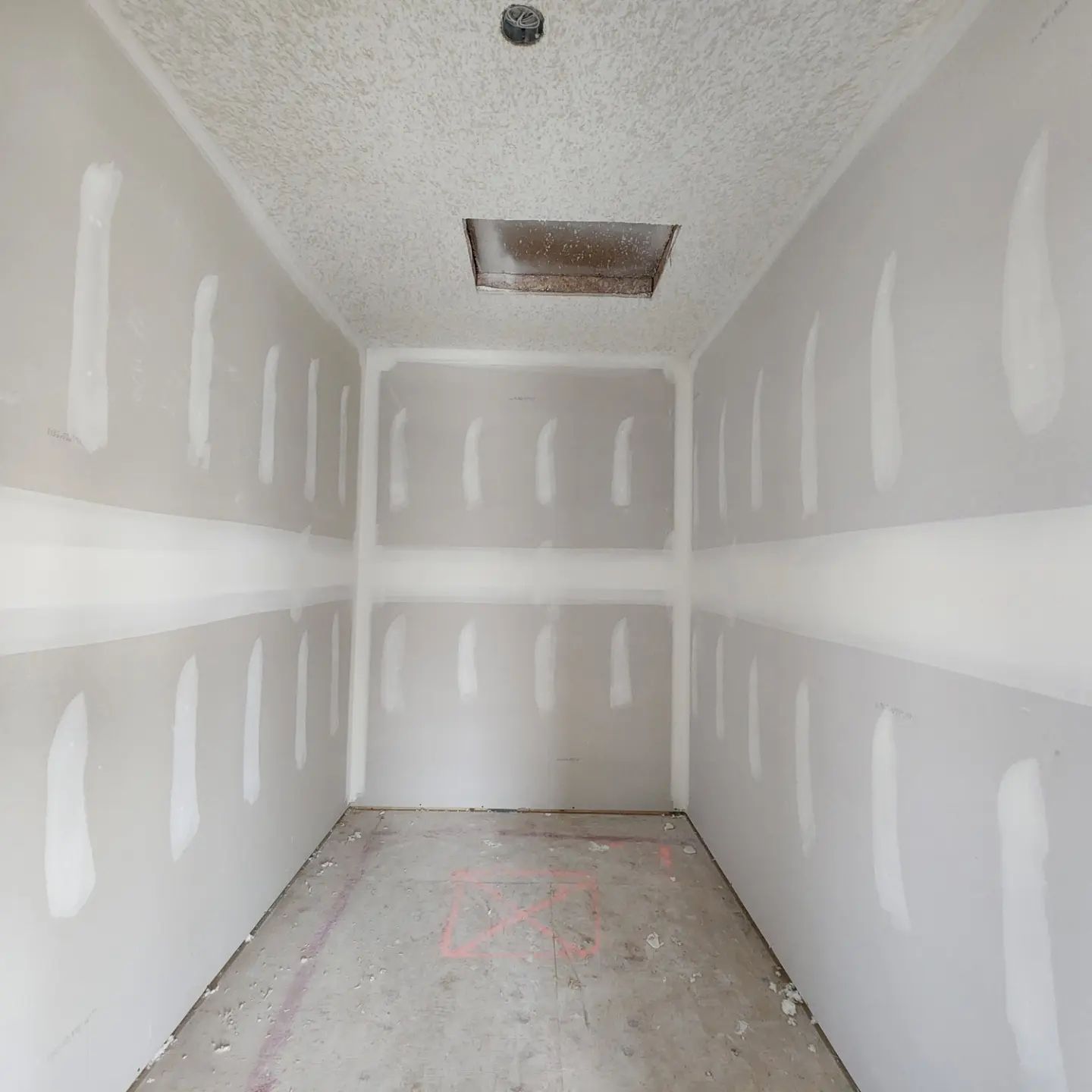 an empty room with drywall walls and a ceiling .