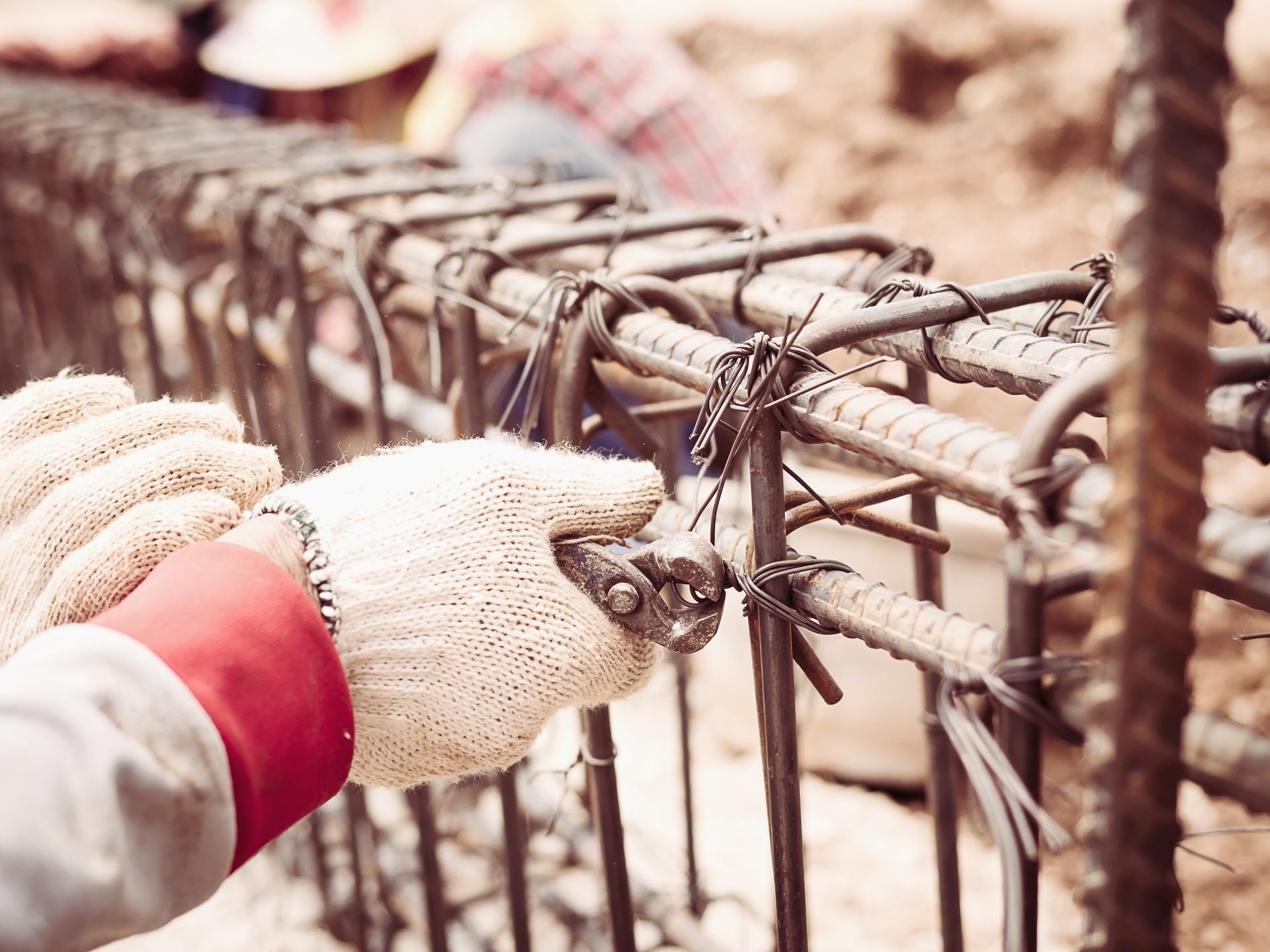 A construction worker is working on a metal structure at a construction site.