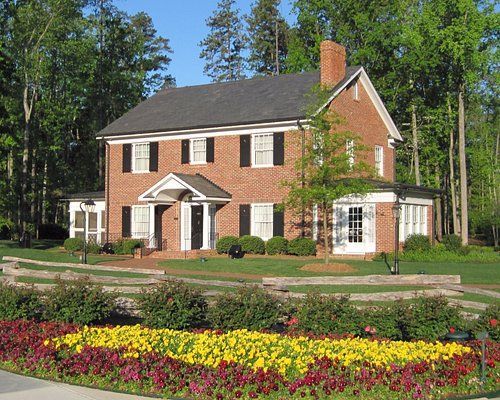 A large brick house with flowers in front of it