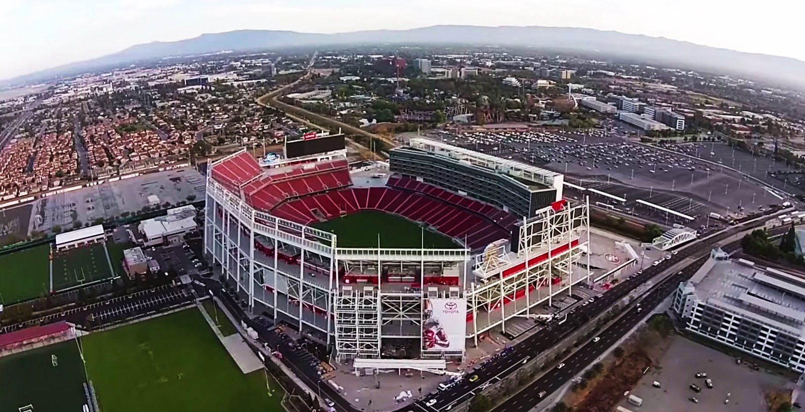 An aerial view of a soccer stadium in a city.