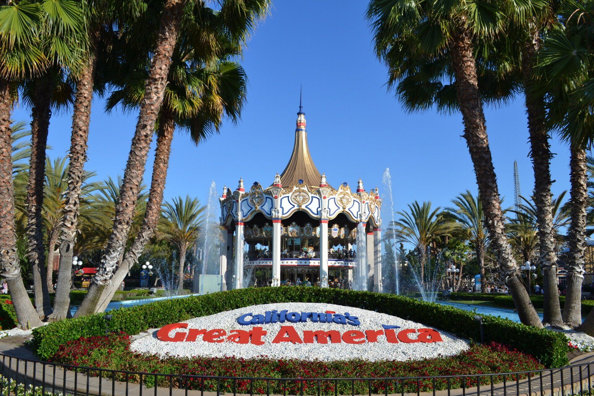 A merry go round in front of a sign that says great america